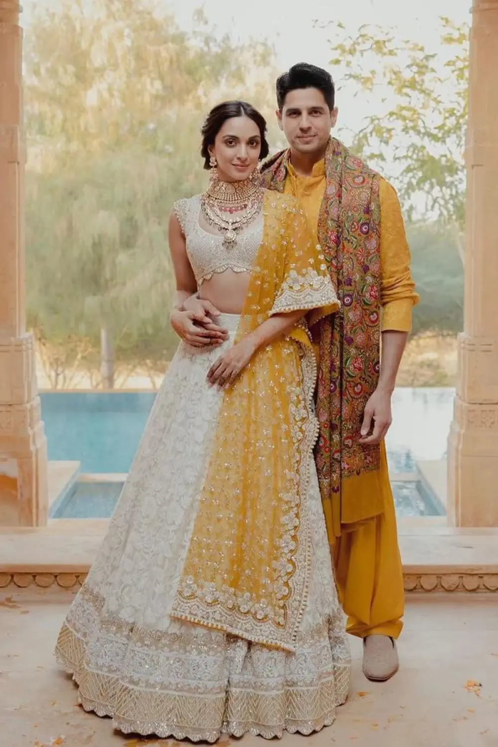 Customized embroidered lehenga choli with dupatta for women and matching 3-piece sherwani set for men, designed by Adahh Fashion Boutique for special occasions